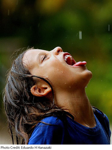 child drinking rainwater